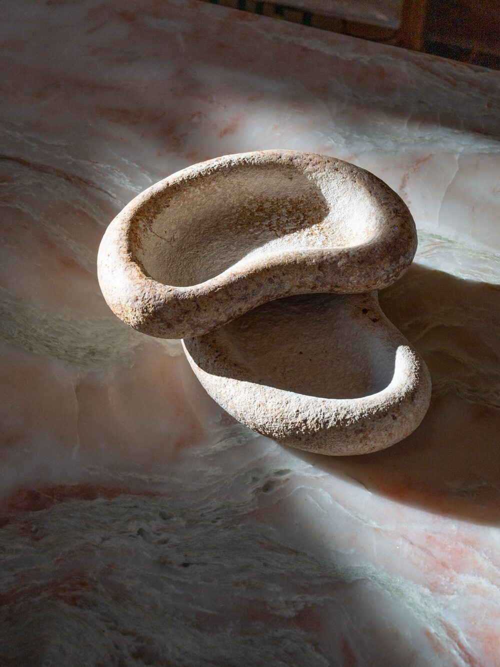 Two grown mycelium bowls nested on a marble counter