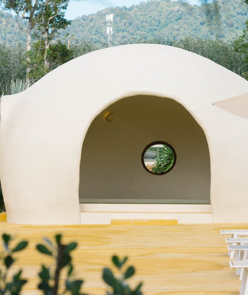 The onsen dome and its round window, the hills of Thalang behind
